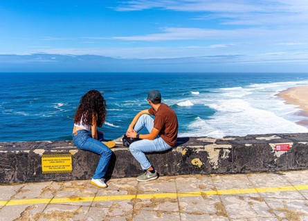 Tourists on the platform of Farol de Nazare lighthouse, Portugal