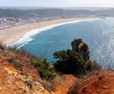 View of the extensive beach from the platform at Farol de Nazare, Portugal