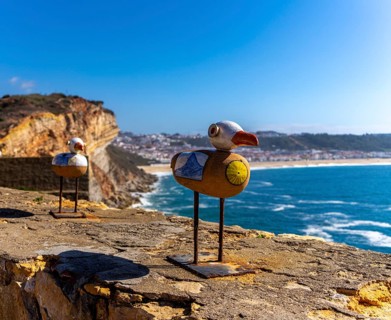 Wooden seagulls, art on the fortress at Farol de Nazare lighthouse, an annual meeting place in