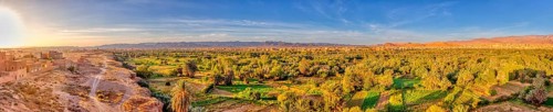 Green oasis landscape at dusk with wide sky and sunset, Tinghir in Morocco