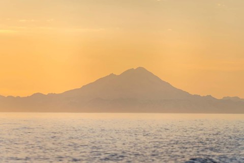 View of Cook Inlet on white mountain peaks of Mount Redoubt at sunset, midnight sun, Aleutian