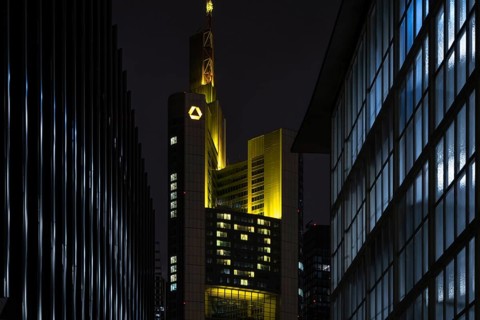 A yellow heart glows on the façade of the Commerzbank Tower in Frankfurt am Main at Christmas time