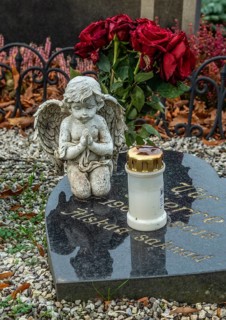 Gravestone with angel and candle in Ystad, Skåne County, Sweden, Scandinavia