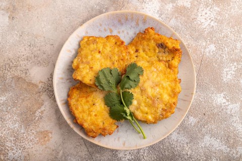 Fried crispy Chicken pancakes on brown concrete background. top view, flat lay, close up