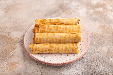 Waffles with caramel on brown concrete background, side view, close up