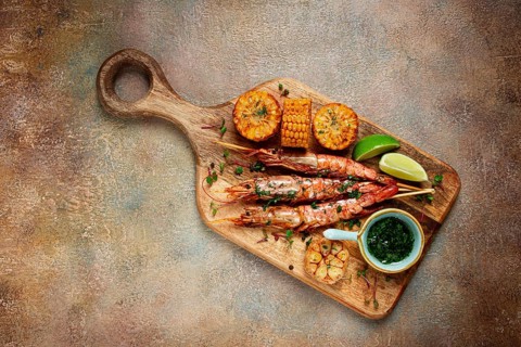 Langoustines on skewers, shrimp kebab, with fried corn, spices and herbs, homemade, no people