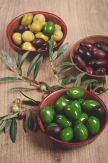 A mixture of olives, varieties of chalkidiki, Verdi giganti and Kalamata, in a bowl, top view, no