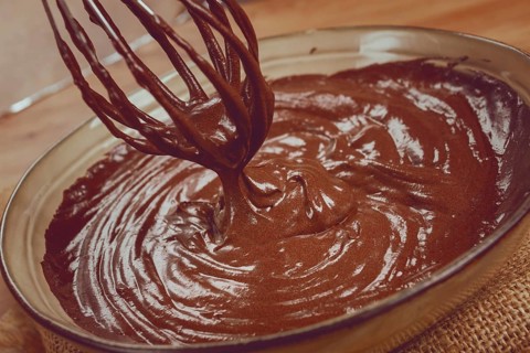 A bowl of chocolate dough, a whisk for whipping, baking, structure and consistency, homemade, top