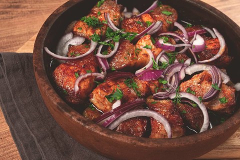 Fried meat, pork kebab, ketsi in a clay pan, with red onions and herbs, homemade, no people