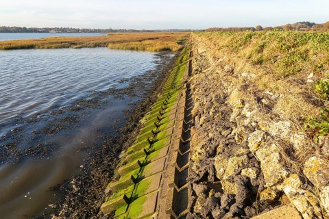 River Deben earthwork bank flood defence wall, Sutton, Suffolk, England, UK