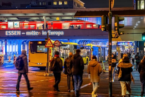 The main train station in Essen, blue illuminated underpass, bus station, am Europaplatz, train on