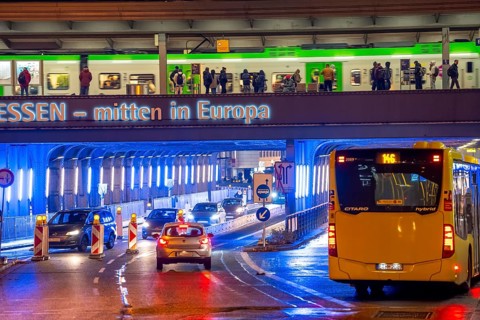 The main train station in Essen, blue illuminated underpass, bus station, am Europaplatz, train on