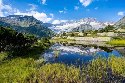 Picturesque mountain landscape, dammastock and damma glaciers reflected in Moorsee, Göscheneralp,