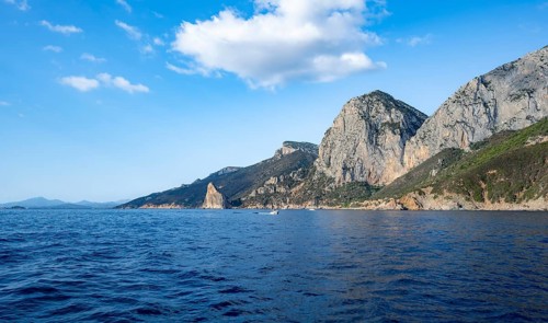 Picturesque rocky coast, cliffs with Pedra Longa pinnacle, blue sea, Golfo di Orosei, Baunei,