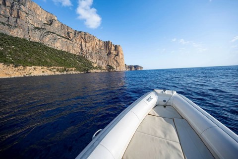 Motorboat trip along the picturesque rocky coast, cliffs and blue sea, Golfo di Orosei, Baunei,