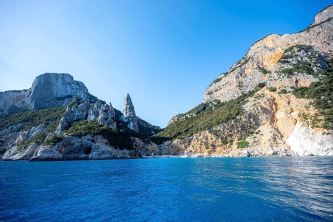 Picturesque rocky coast, cliffs with L'Aguglia pinnacle, blue sea and Cala Goloritzé beach, Golfo