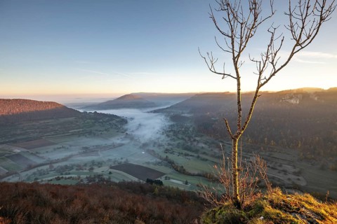 Sunrise with fog in the Neidlinger Valley with a view of the Reussenstein castle ruins. Swabian