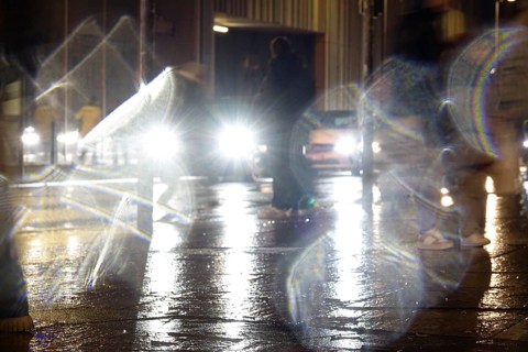 Passers-by in the evening in rainy weather in a city, November, Germany