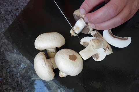 Southern German cuisine, preparing mushrooms, raw mushrooms, cutting, kitchen knife, men's hands,