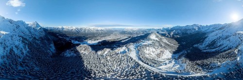 Wonderful winter landscape with Zugspitze, blue sky and snow, mountains and mountain valley, aerial