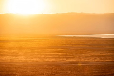 View of savanna landscape at sunrise, atmospheric morning light, view of Ngorongoro Crater, back