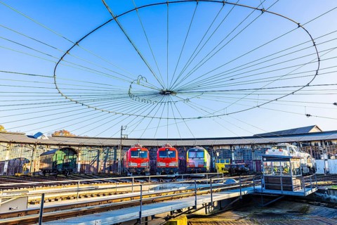 Turntable and overhead line spider, behind it modern locomotives of the Austrian Federal Railways,