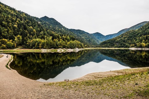 Picturesque mountain lake with water reflections in autumn, Lac de Kruth-Wildenstein, Kruth,