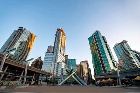 Olympic Cauldron Statue, Jack Poole Plaza Square, skyscrapers on the promenade at sunset, Coal