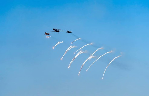 The Indian Air Force aerobatic team performs during an air show as part of the 93rd Air Force Day
