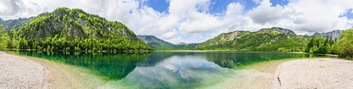 Landscape of Lake Offensee after rain when the sun comes through the clouds in spring,