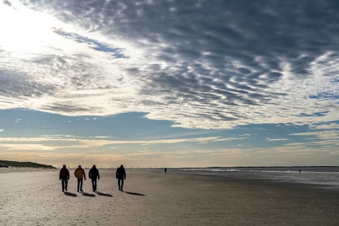Walkers on the Wadden Sea near the East Frisian island of Spiekeroog, west of the North Sea island,