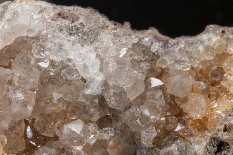 Vibrating quartz crystals mix with rock formations and capture light in a natural spring atmosphere