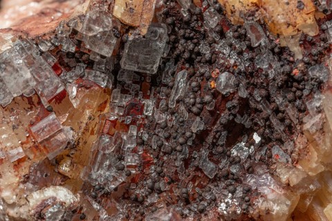 Transparent crystals sit on rocks and reveal their unique shimmer and geological structure. The