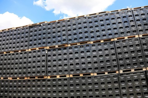 Stacked black beer crates from the Kulmbacher Group, a beverage manufacturer that includes