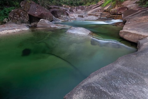 Turquoise blue water between rocks in the tropical rainforest of Babinda Boulders Queensland