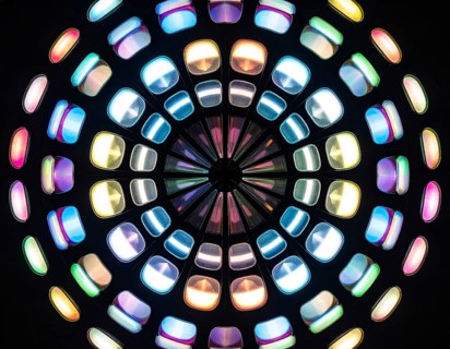 Abstract background of slightly unfocused multicolored glass lenses spinning and rotating,