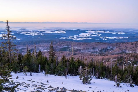 View from Mount Lusen over the hills of the bavarian forest at sunrise in winter, Bavaria, Germany