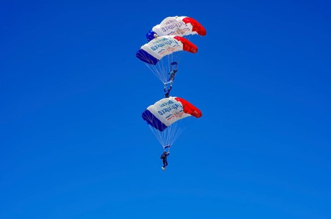 Skydivers during an aerial acrobatic performance as part of an air show at the Fliegerbergfest of