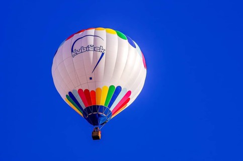 A hot air balloon, registration D-OÖJ, rises into the air as part of an air show at the