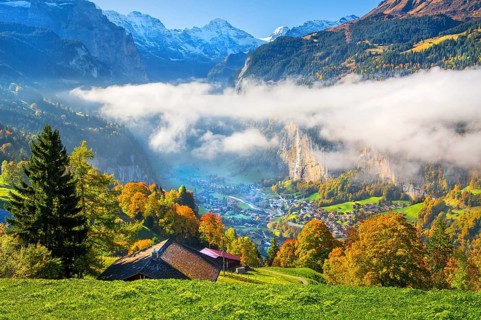 View from the village of the Lauterbrunnen Valley with Staubbach waterfall in autumn with morning