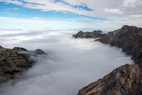 View from the Nebelhorn summit to mountains of the Allgäu Alps, mountains rising from fog in the