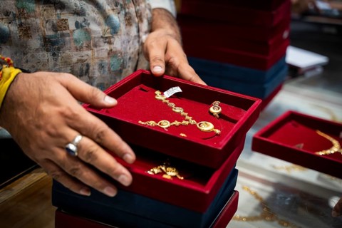 Customers purchase Gold jewelry at a store on the occasion of the festival of Dhanteras, in