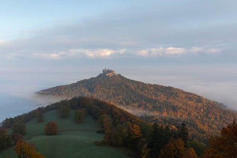 Hohenzollern Castle in a sea of fog at sunrise, autumn in the Swabian Jura
