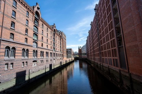 Canal between red brick buildings, warehouses in Hamburg's Speicherstadt, Hamburg, Germany