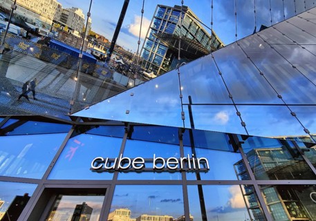 Cube Berlin, cube-shaped office building with inwardly folded glass façade reflecting the
