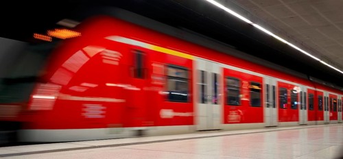 Underground arriving S-Bahn, train, class 420 in traffic red, platform, stop, station city centre,