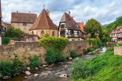Picturesque Kaysersberg with half-timbered houses on the Weiss river in the old town centre