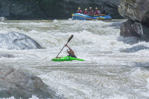 Young man kayaking in river, Costa Rica, Central America
