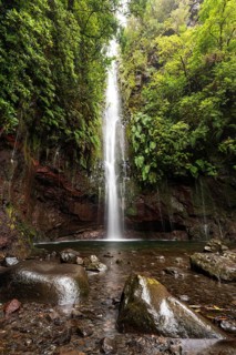 A large waterfall and many small watercourses pour down onto the rocks in the mystical 25 Fontes