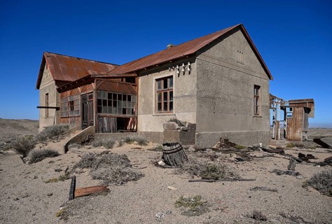 Dilapidated building in the desert sand, Pomona, restricted diamond area, near Lüderitz, Karas